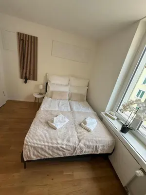 a bedroom with a bed with two towels on it at St Gallen City - 5 min vom Bahnhof - Roter Platz in St. Gallen