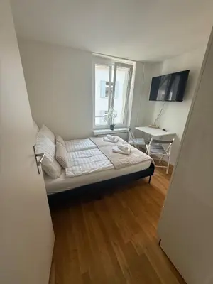 a small room with a bed and a window at St Gallen City - 5 min vom Bahnhof - Roter Platz in St. Gallen