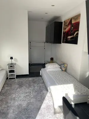 a small room with a bed and a couch at 1-room studio apartment in St. Gallen