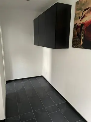 a room with a black cabinet on the wall at 1-room studio apartment in St. Gallen