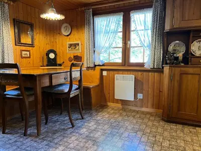 a dining room with a wooden table and chairs at Beatli Chalet in Wildhaus