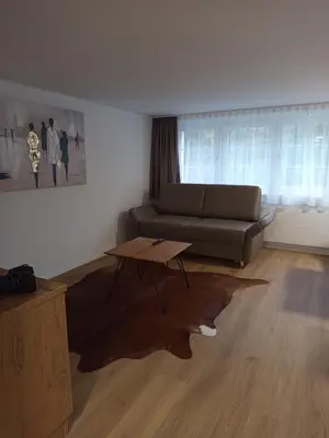 a living room with a couch and a coffee table at Gästehaus Rossfall 424 - Self-Check-in in Urnäsch