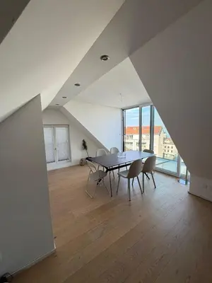 a dining room with a table and chairs at Elegante Maisonette mit See-Panorama in Rorschach in Rorschach