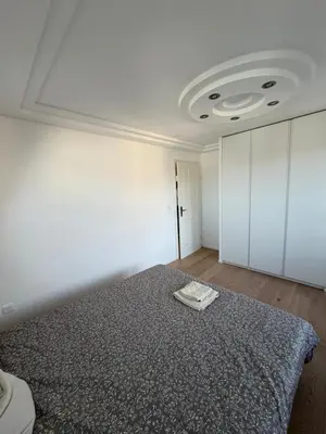a bedroom with a bed and a white ceiling at Elegante Maisonette mit See-Panorama in Rorschach in Rorschach
