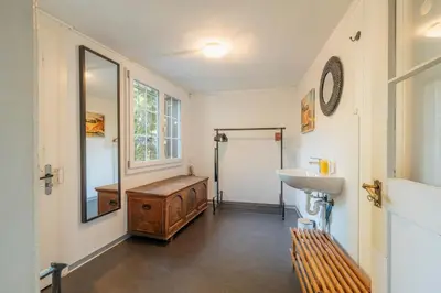 a bathroom with a sink and a toilet and a mirror at Das aussergewöhnliche Gäste- und Ferienhaus in Güttingen