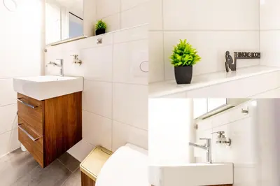 a bathroom with two sinks and a mirror at Gemütliche Souterrainwohnung mit gratis Parkplatz in St. Gallen