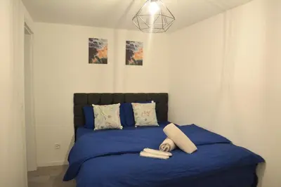 a bedroom with a blue bed with two towels on it at Luxuswohnung in Bodensee, im Radweg mit Parkplatz in Romanshorn