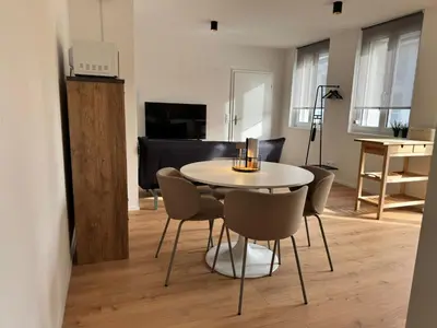 a dining room with a table and chairs in a room at Alte Näherei in Degersheim