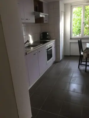 a kitchen with a sink and a stove top oven at 3 Zi Gartenwohnung in Buchs