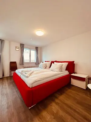 a bedroom with a large red bed in a room at Romantic Room, Private Bathroom and Great View in Heiden
