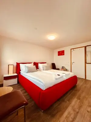 a large red bed in a room at Romantic Room, Private Bathroom and Great View in Heiden