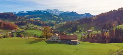 a house on a hill in a green field at BnB Sonder in Urnäsch