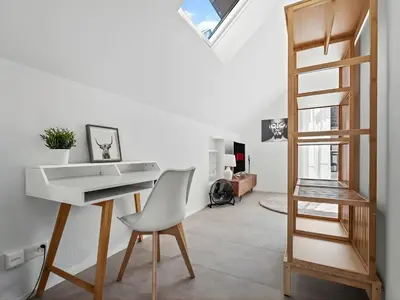 a white desk and a white chair in a room at Ferienhausträume Bergstrasse Bodensee - inkl Tiefgarage, Garten und Dachterrasse in Kreuzlingen