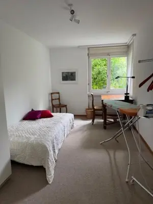 a bedroom with a bed and a desk and a window at 3 Zimmerwohnung mit Gartenterrasse, mitten im idyllischen Gais für 1 bis 3 Personen in Gais