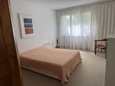 a bedroom with a bed and a large window at 3 Zimmerwohnung mit Gartenterrasse, mitten im idyllischen Gais für 1 bis 3 Personen in Gais