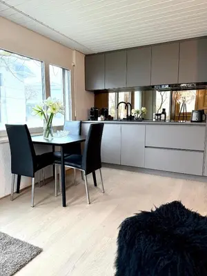 a kitchen with a table and some chairs and a counter at Luxus Studio Apartment am Bodensee in Güttingen