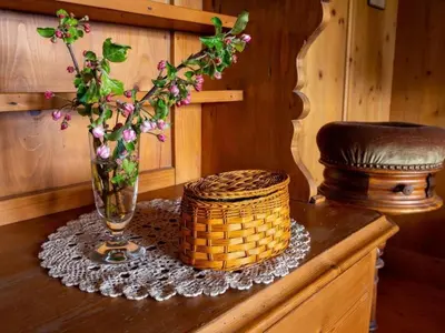 a vase with flowers in it on a table at Holiday Home Fromsenrüti by Interhome in Walzenhausen