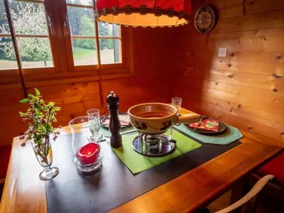a wooden table with a bowl of food on top of it at Holiday Home Fromsenrüti by Interhome in Walzenhausen