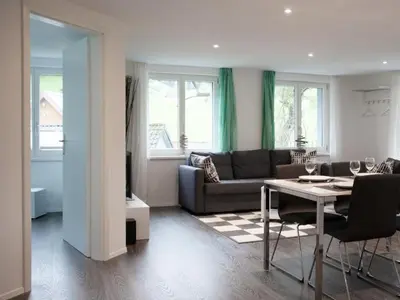 a living room with a couch and a table at Apartment Ferien im Toggenburg by Interhome in Krummenau