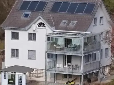 a house with solar panels on top of it at Apartment Ferien im Toggenburg by Interhome in Krummenau