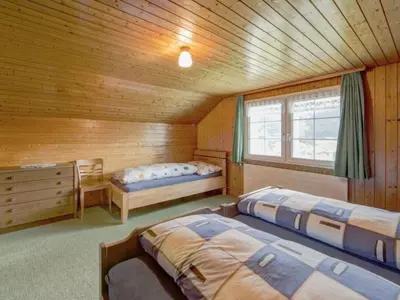 a bedroom with two beds in a wooden cabin at Apartment Hautle by Interhome in Appenzell Innerrhoden