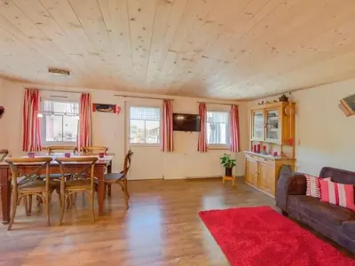 a living room with a table and a couch at Apartment Bauernhof Fendrig - neue Wohnung by Interhome in Haslen