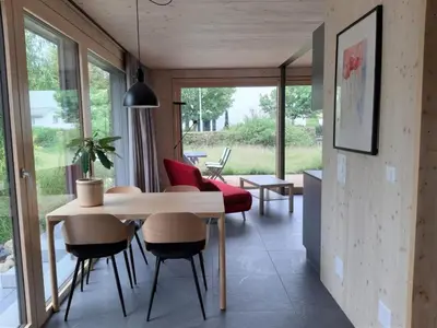 a dining room with a table and chairs and a window at Holiday Home Gartenbungalow 2 - 3 Personen by Interhome in Arbon