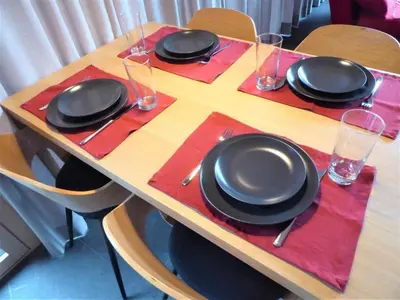 a wooden table with black plates and glasses on it at Holiday Home Gartenbungalow 2 - 3 Personen by Interhome in Arbon