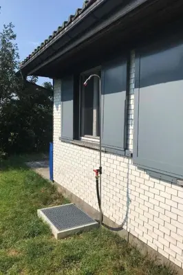 a house with a hose hooked up to a window at Holiday Home Soldanella by Interhome in Appenzell