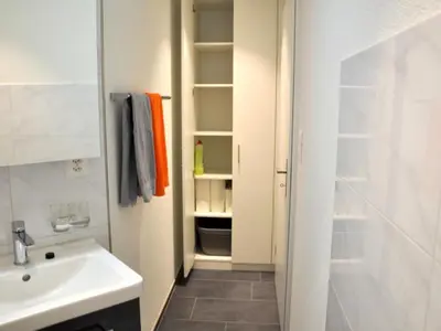 a bathroom with a sink and a toilet and a sink at Apartment Rätia by Interhome in Wolfhalden