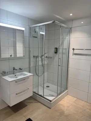 a bathroom with a shower and a sink at McNeal Solutions Zentrale Lage direkt am Roten Platz in St. Gallen