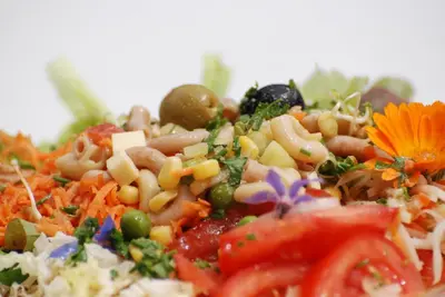 a plate of food with vegetables and other foods at Sonnmatt Bergpension & Gesundheitszentrum in Ebnat