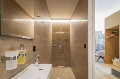 a bathroom with a shower and a white sink at Säntis - das Hotel in Schwagalp