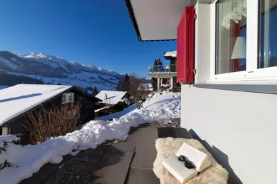 a pair of shoes sitting on a window sill in the snow at Studio Muerner in Wildhaus