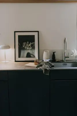 a kitchen counter with a picture and a sink at 4 bedroom house for 8 guests in Brülisau
