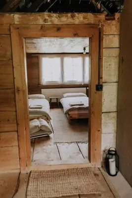 an open door to a room with two beds at Quiet exclusive house for 6 people in Brülisau