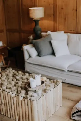 a wooden coffee table with candles in a living room at Zimmer Fählensee im Appenzeller Ferienhaus in Brülisau