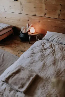 a bedroom with a bed and a wooden wall at Zimmer Appenzell im Appenzeller Ferienhaus in Brülisau