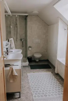 a bathroom with a sink and a shower and a toilet at Zimmer Appenzell im Appenzeller Ferienhaus in Brülisau