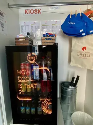 a refrigerator with a drink cooler in a room at Hotel Garni Rössli in St. Gallen