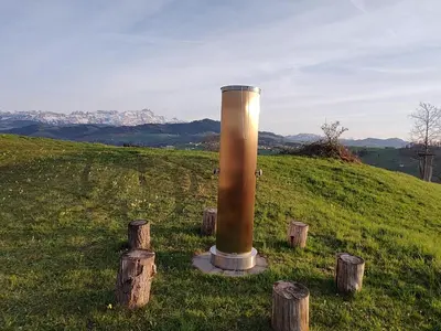 a pole in the middle of a field with logs at Apartment sunehus-ch by Interhome in Stein