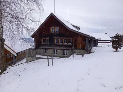 a large wooden house with snow on the ground at Holiday Home Ferienhaus- - Stöckli Klingenbuch 20 by Interhome in Rehetobel