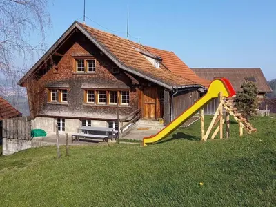 a house with a slide in front of it at Holiday Home Ferienhaus- - Stöckli Klingenbuch 20 by Interhome in Rehetobel