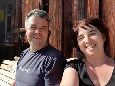 a man and a woman sitting on a bench at Apartment Hof Bommes by Interhome in Gais