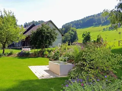 a garden with a box in the middle of a yard at Apartment Vordere Au by Interhome in Schwellbrunn