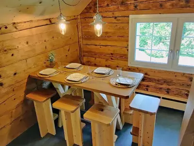 a dining room with a table and chairs in a cabin at Apartment Bauernhaus VordereAu by Interhome in Schwellbrunn