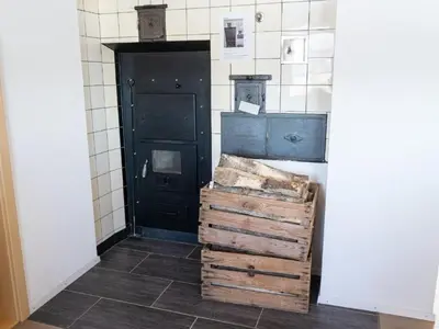 a room with a black door and some wooden crates at Holiday Home Hörli by Interhome in Sankt Peterzell