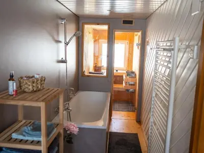 a bathroom with a bath tub and a sink at Holiday Home Hörli by Interhome in Sankt Peterzell