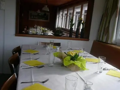 a table with a white table cloth and yellow napkins at Holiday Home Frohheim by Interhome in Sankt Peterzell