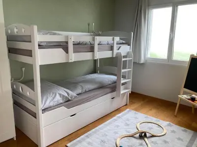 two bunk beds in a room with a desk at Apartment Seehof by Interhome in Rorschacherberg
